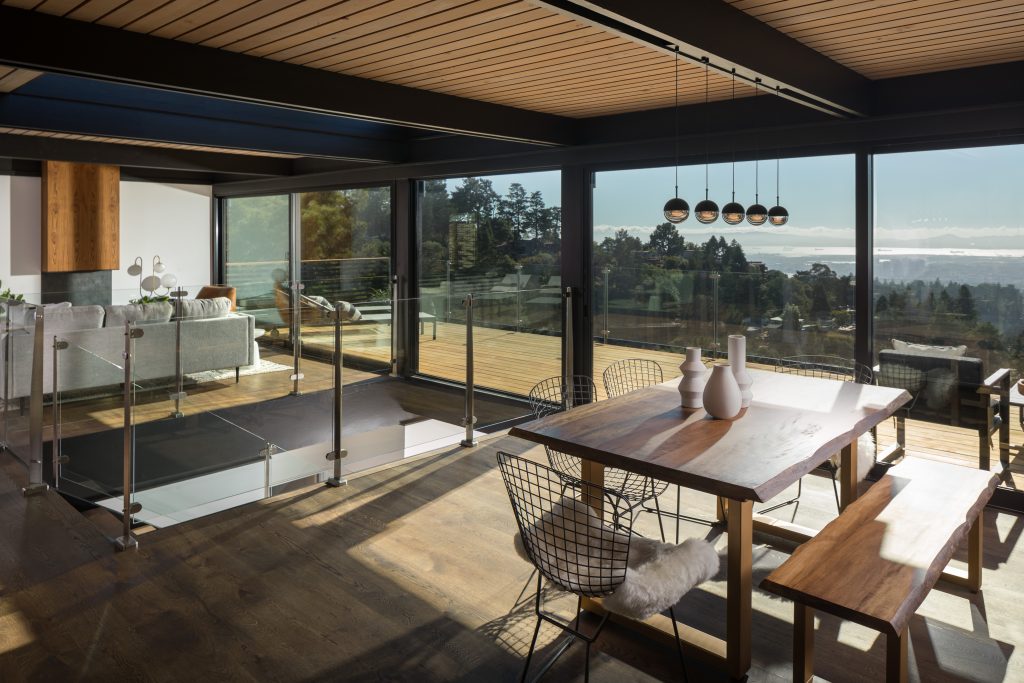 Glass Railing System on deck with patio chairs and table